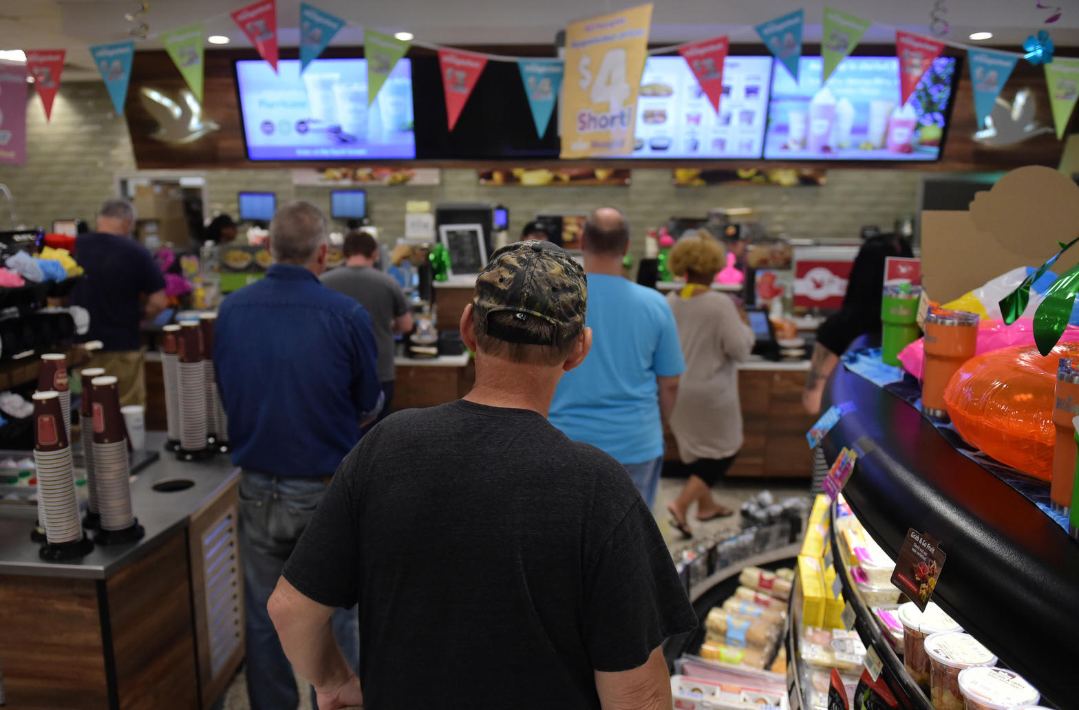 Customers waiting in line at a convenience store